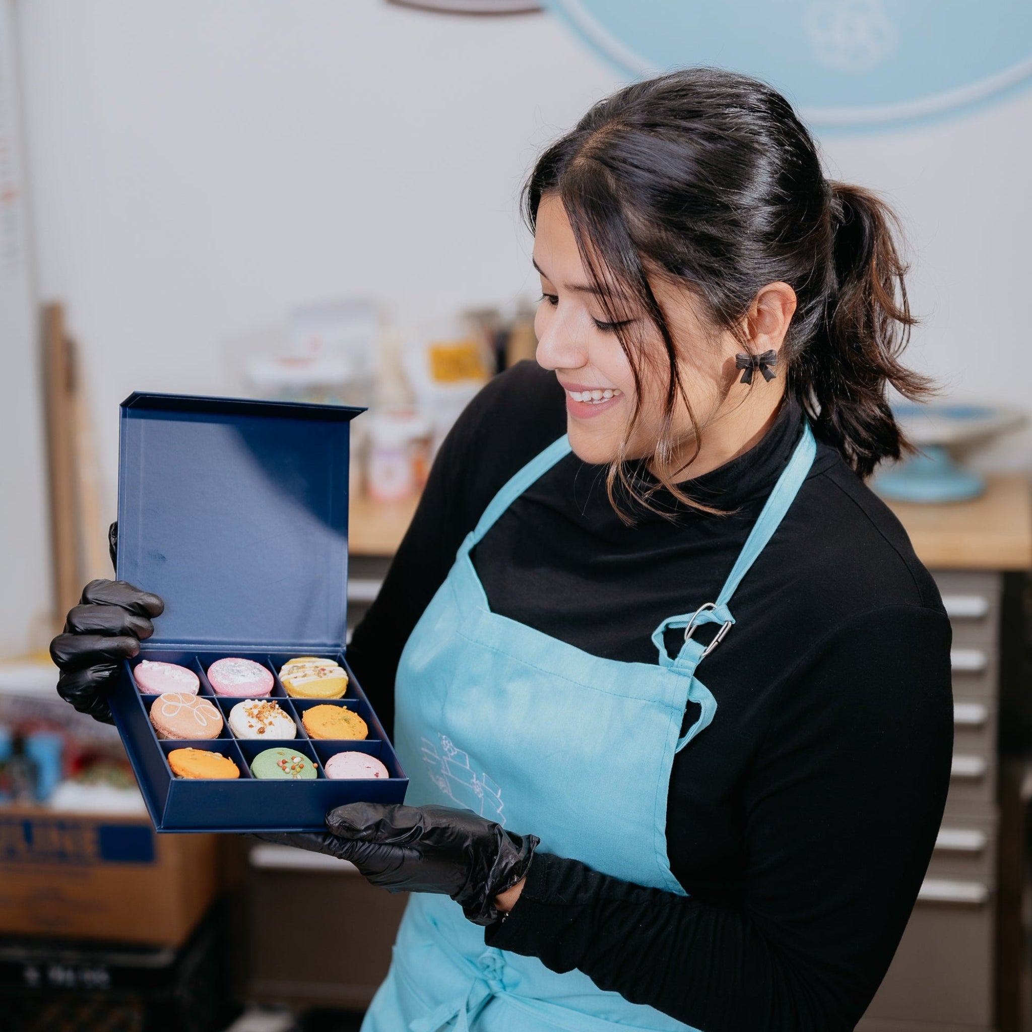 macaron baker holding luxury macaron packaging in toronto
